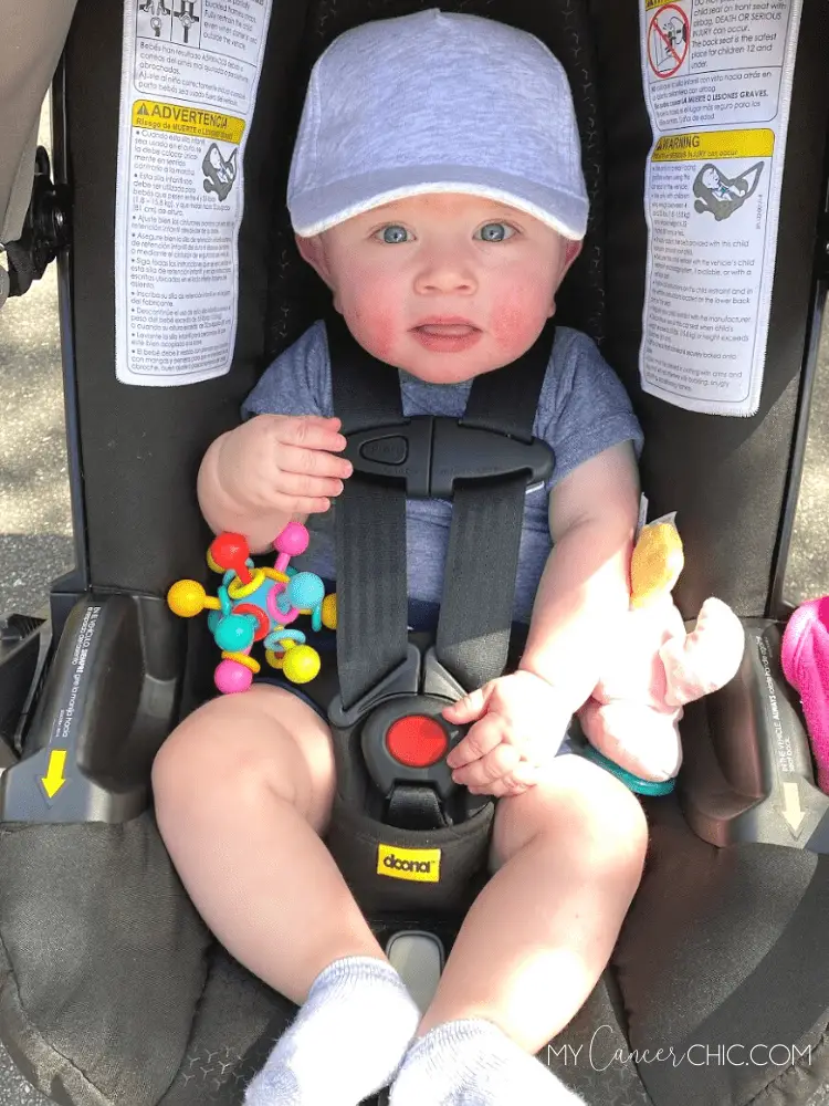 Baby in doona stroller with toy _must have baby items you actually need