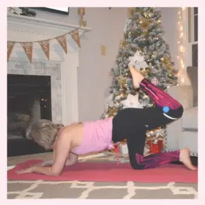 woman exercising at home during the holidays christmas tree