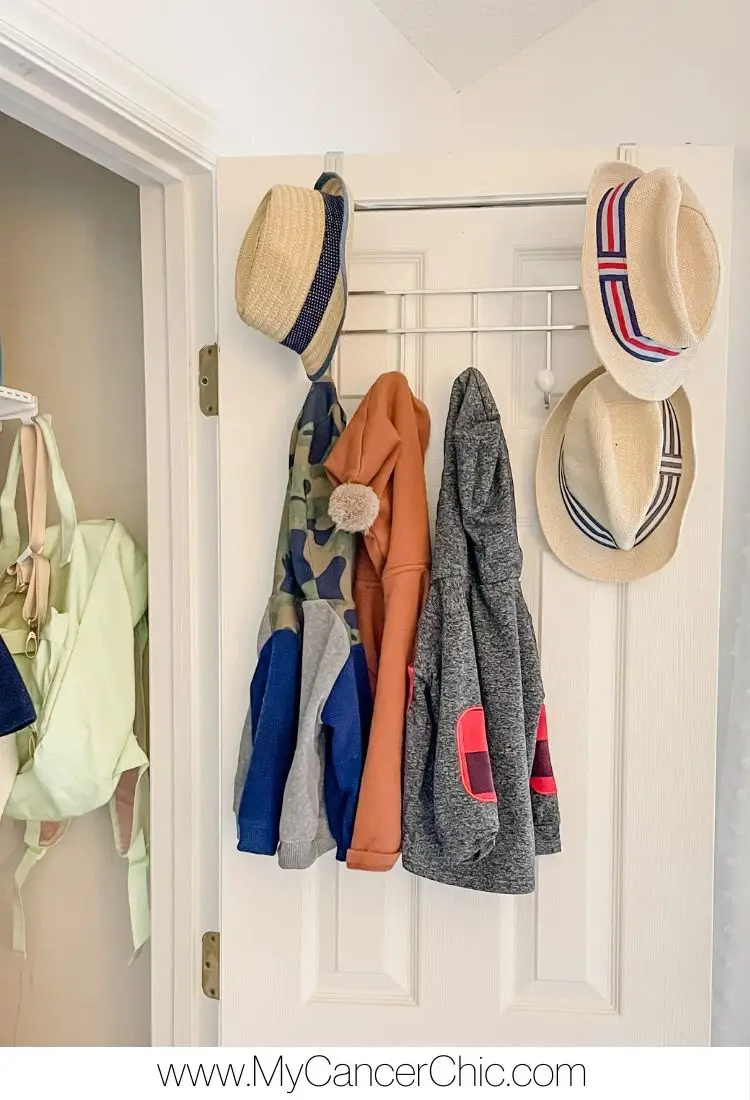 hang clothes at the back of the door as part of organize toddler bedroom