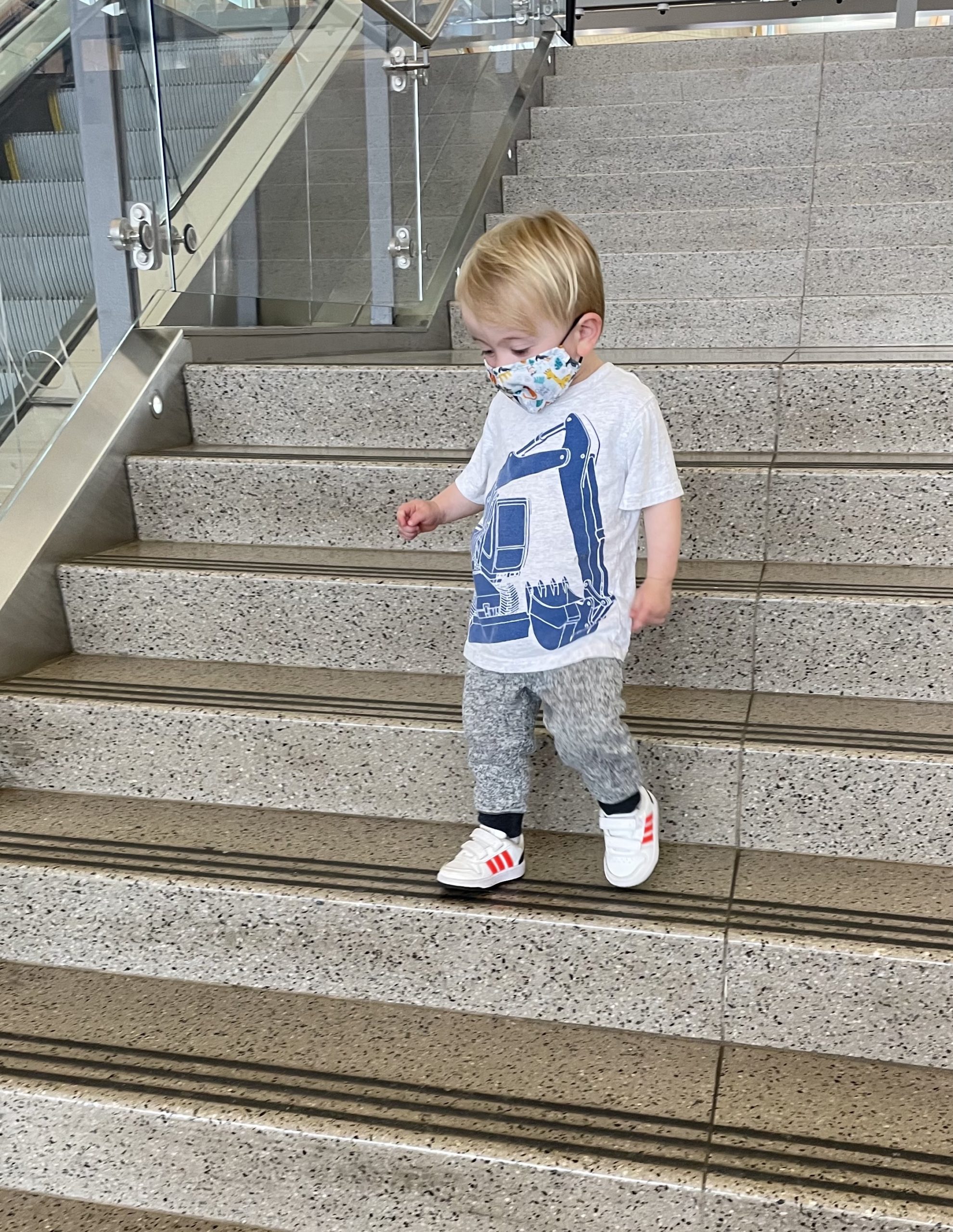 traveling with a toddler on a plane - toddler walking on airport steps