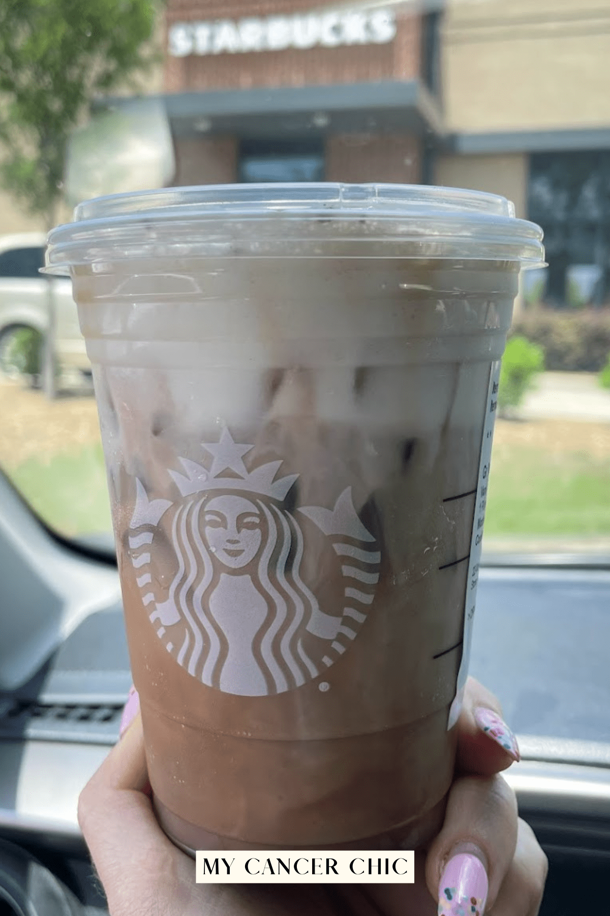 starbucks iced coffee in car window