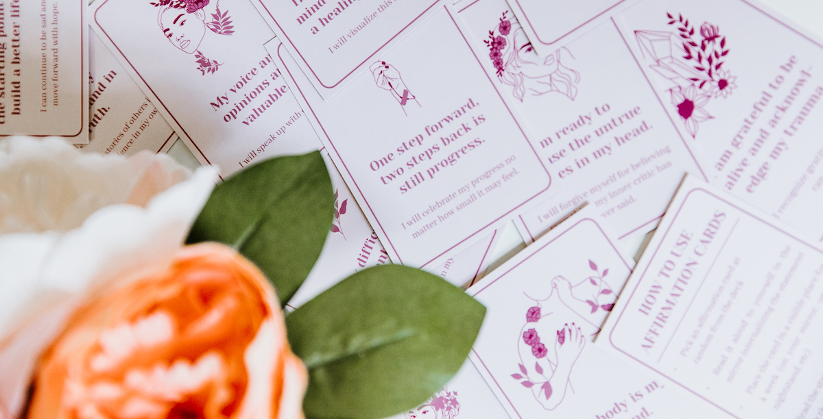 scattered affirmation cards with flowers