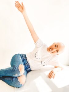 bald woman with boob shirt